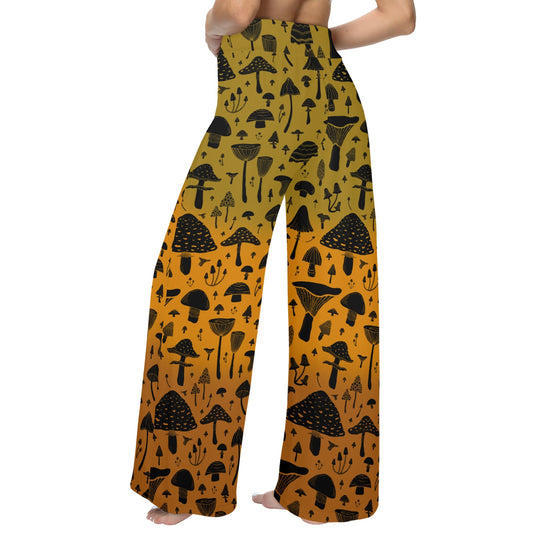 Wide-leg pants with black mushroom pattern on a mustard yellow background