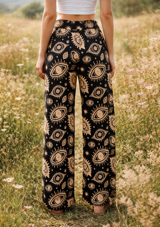 Person wearing eye patterned high waist lounge pants standing in a field