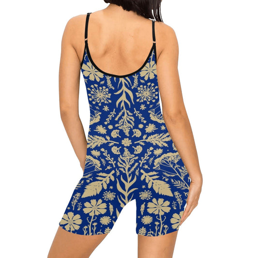 Woman wearing a blue and beige floral patterned romper on a white background