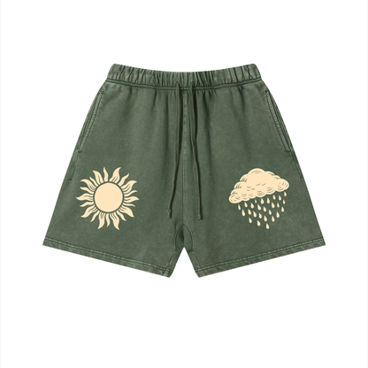 Green shorts with sun and cloud designs on a white background