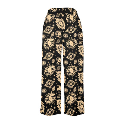 Black pants with gold eye pattern on a white background