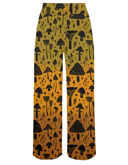 Yellow pants with black mushroom pattern and close-up of fabric texture on a white background