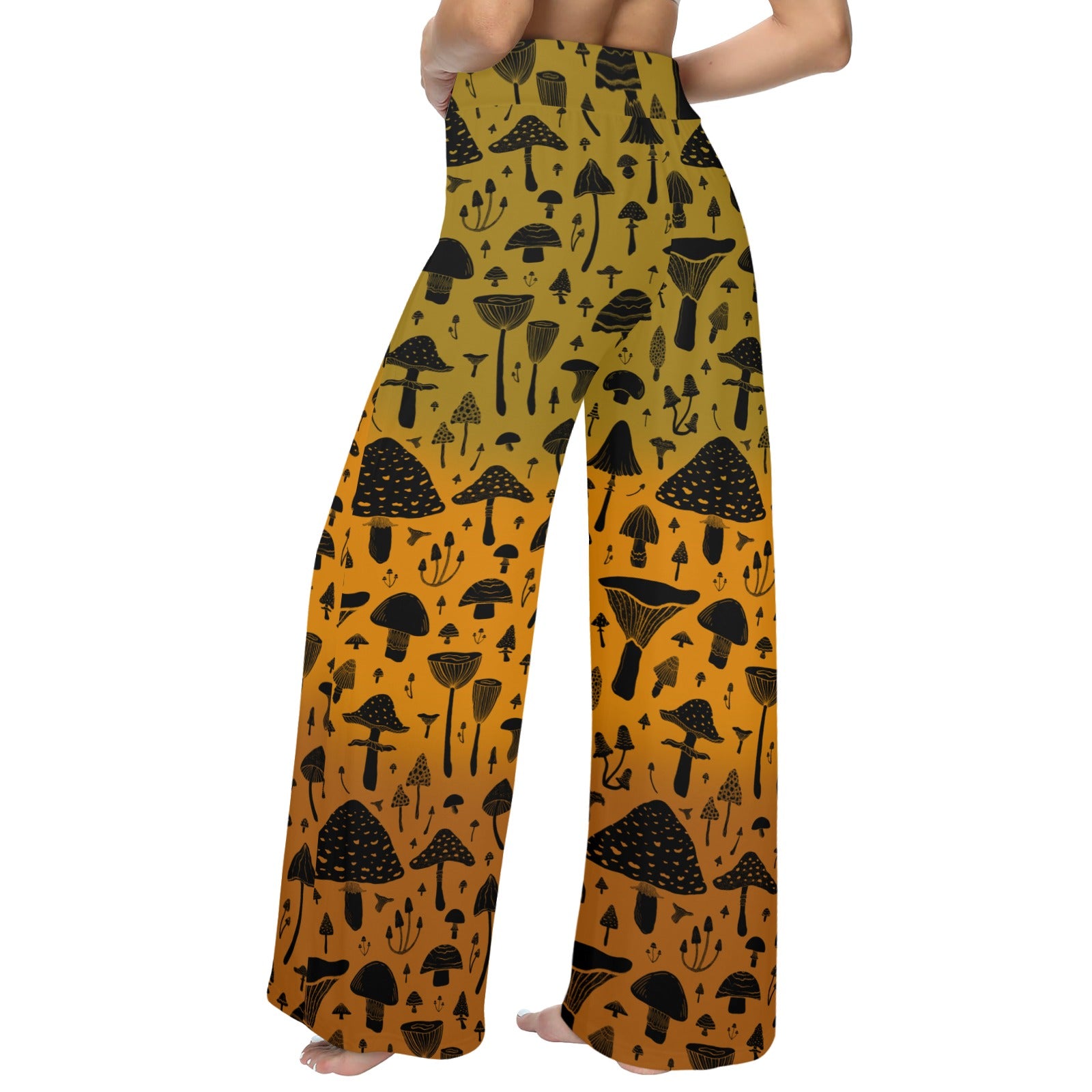 Wide-leg pants with black mushroom pattern on a mustard yellow background