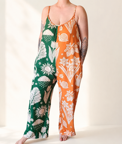 Person wearing a green and orange floral-patterned outfit on a white background