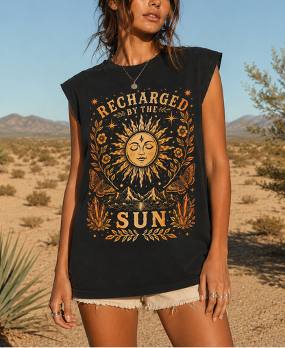 Woman wearing a black sleeveless shirt with sun design and 'Recharged by the Sun' text in a desert setting.