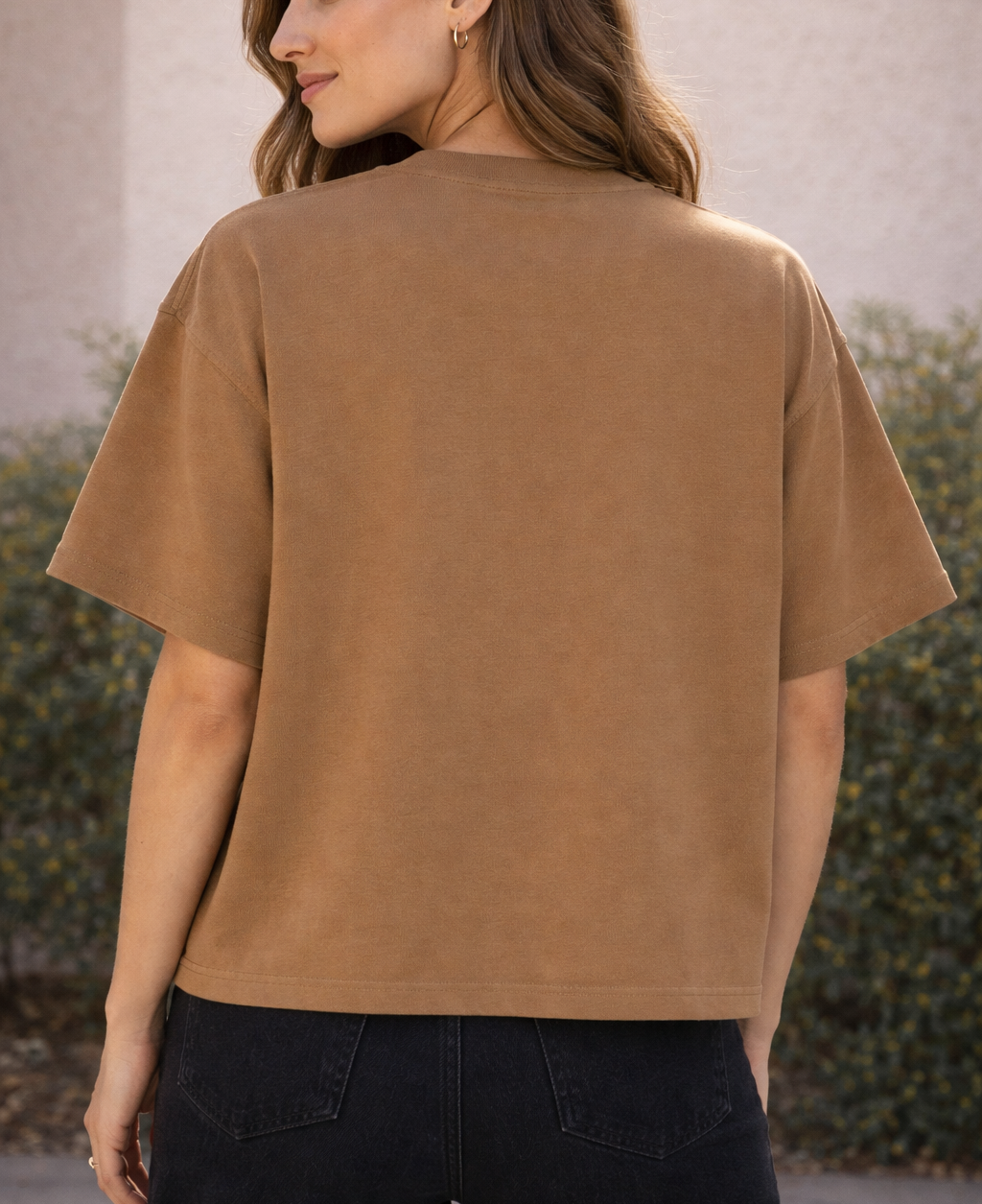 Woman wearing a brown t-shirt with a blurred background