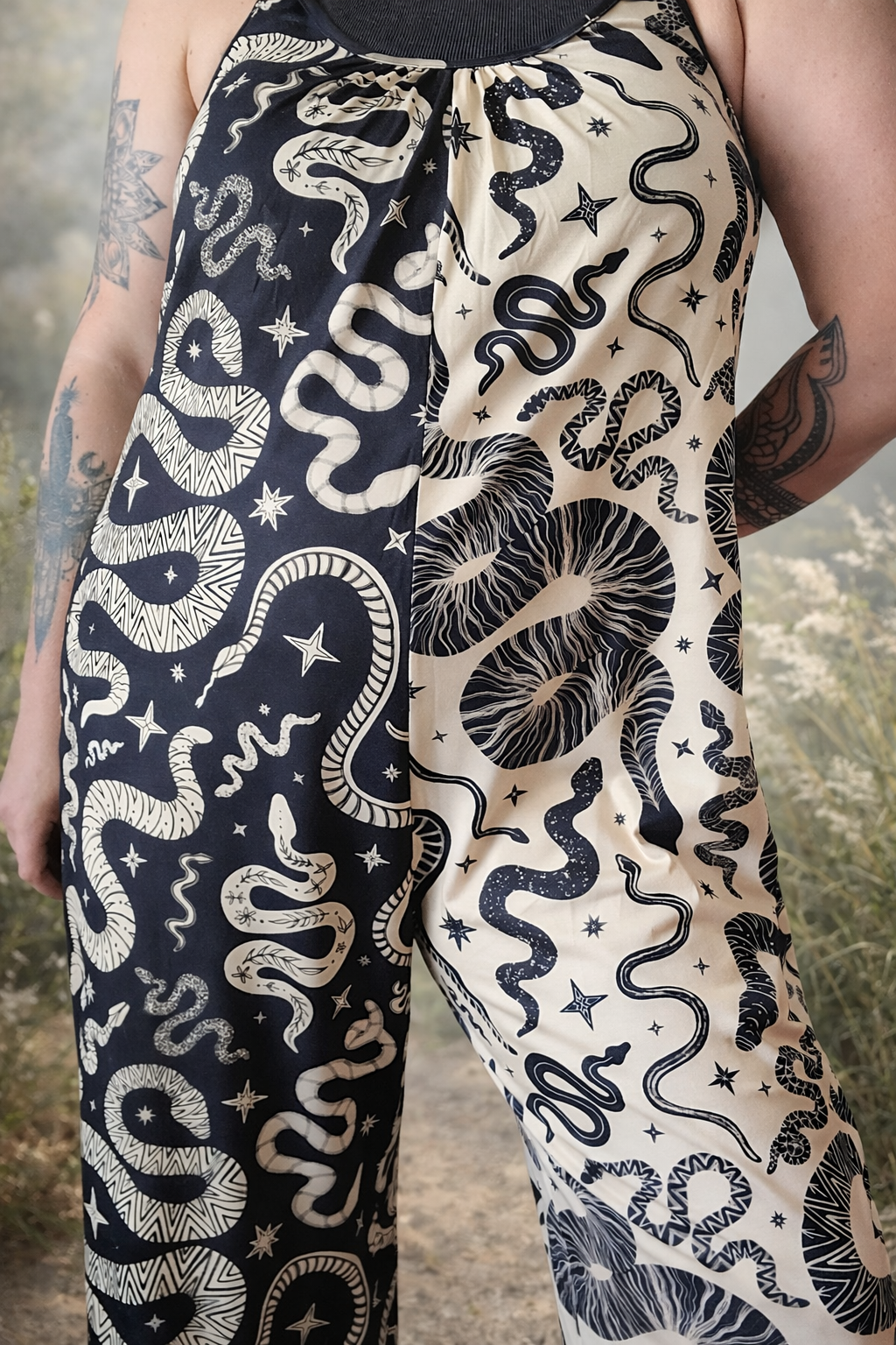 color block jumpsuit with snake and star pattern on a dark background