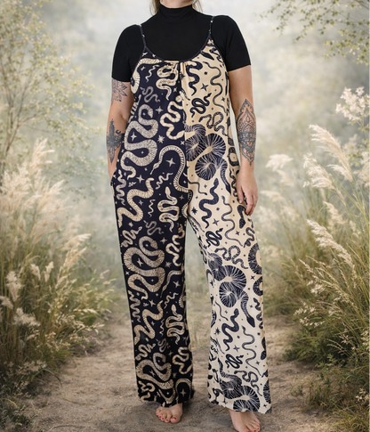 Person wearing a color block snake patterned jumpsuit standing in a natural setting with trees and grass.