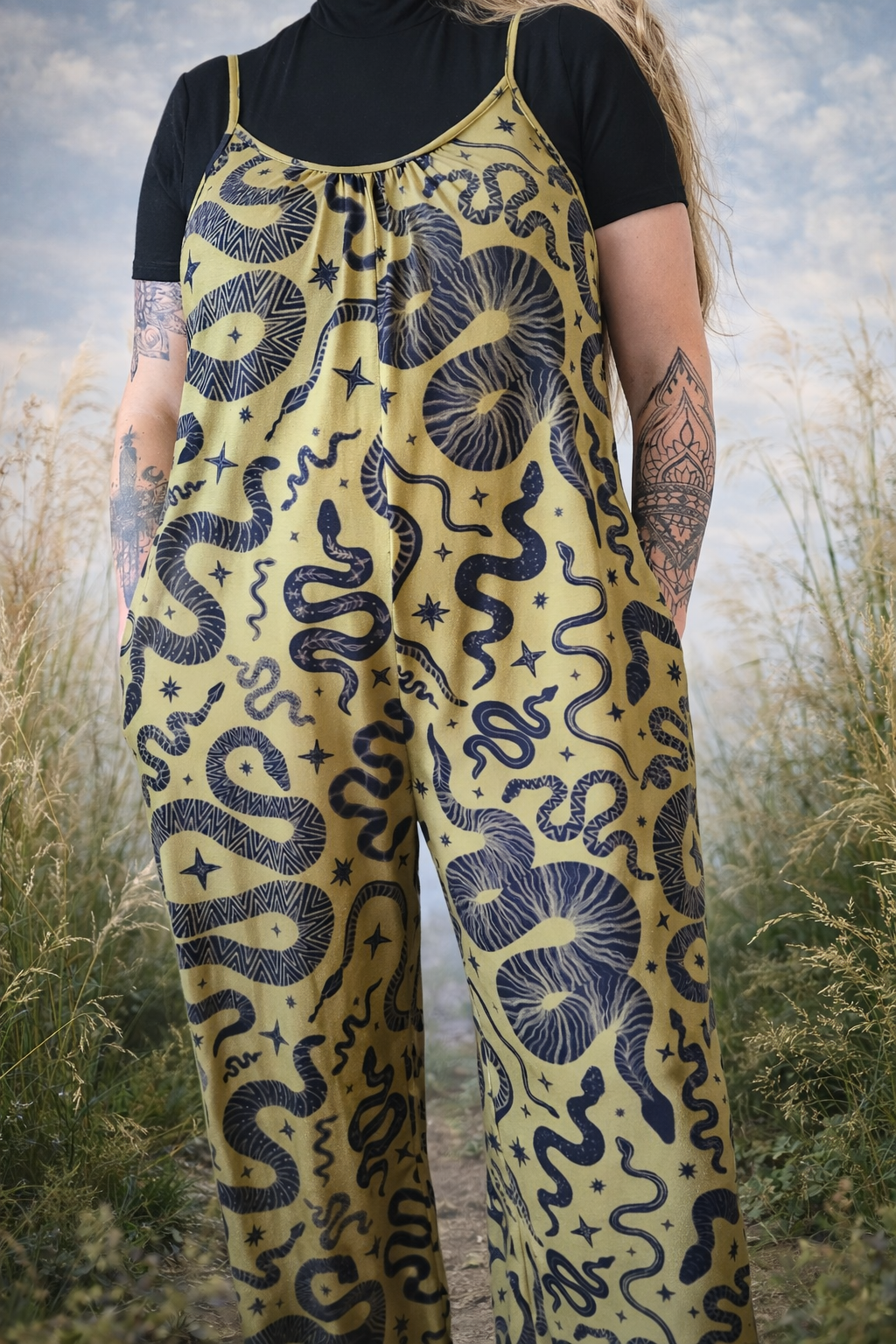 Person wearing a green jumpsuit with black snake pattern in an outdoor setting