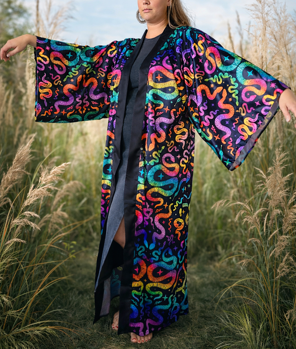 Person wearing a colorful snake-patterned kimono in a natural setting